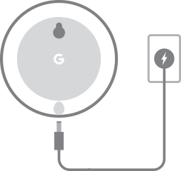Google Nest Mini ligado na tomada de energia elétrica.